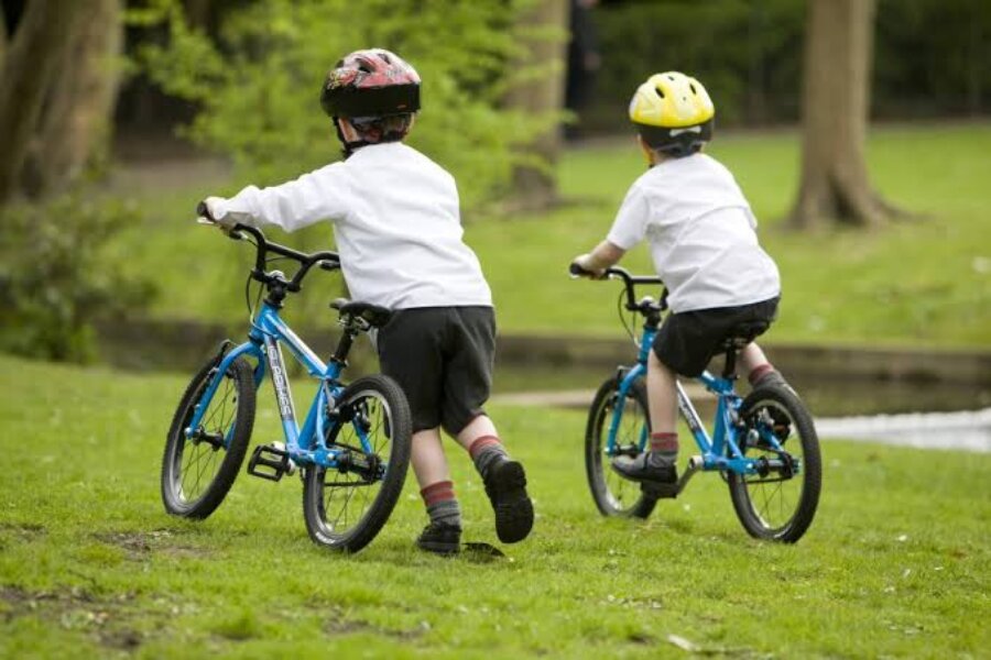 two kids with bicycle