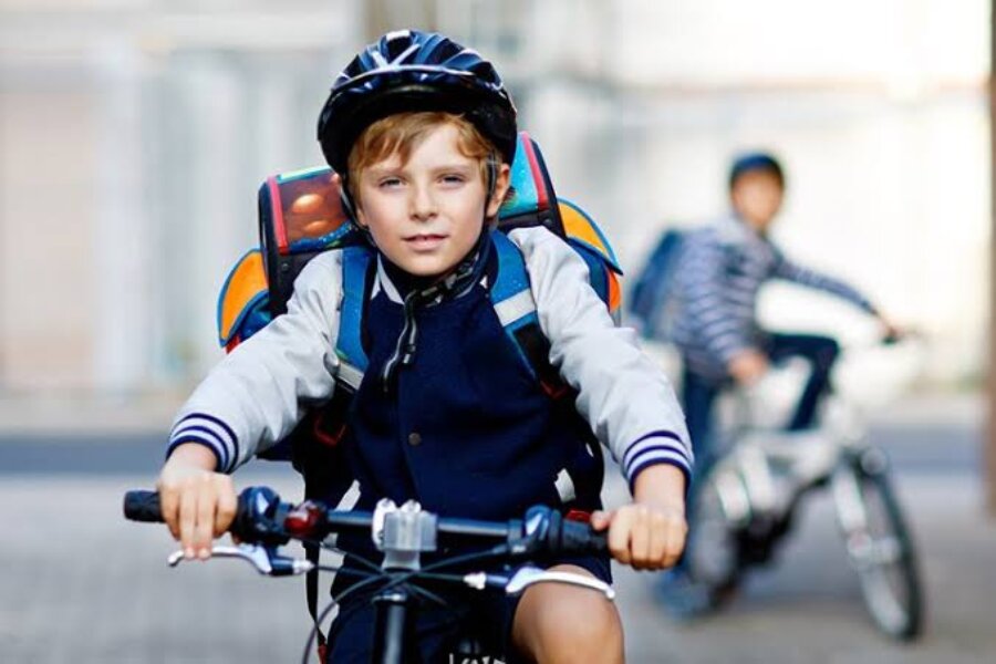 A boy cycling on the road